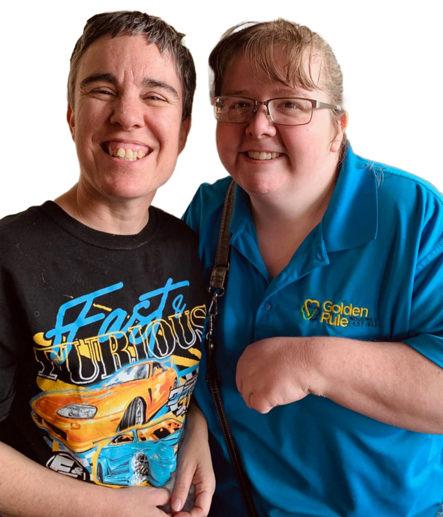 Two smiling team members, one wearing a Golden Rule Industries polo, friendly team photo
